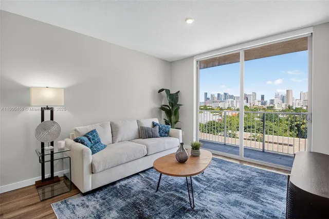 a living room with furniture and a large window