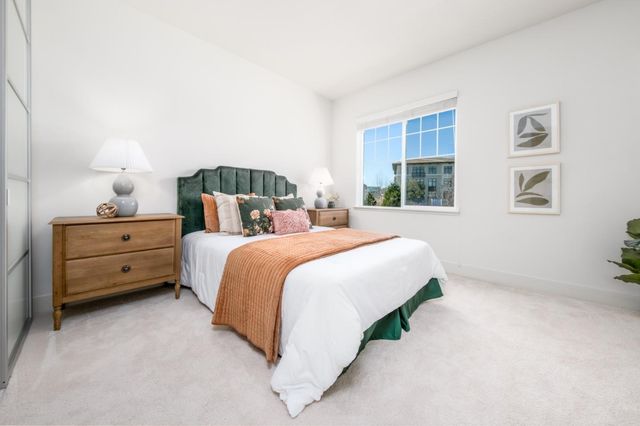 a bed room with a bed and a night stand