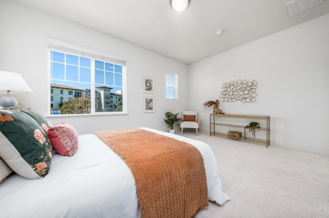 a bedroom with furniture and a large window