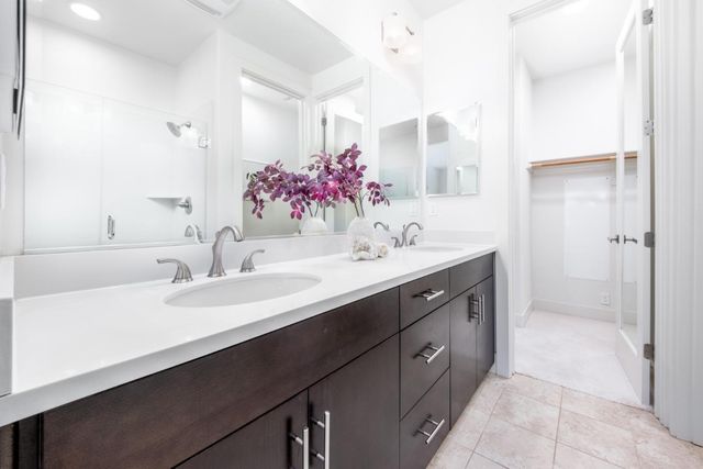 a bathroom with a sink vanity tub and shower