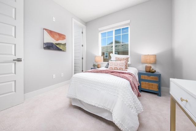 a bedroom with a bed and a large window