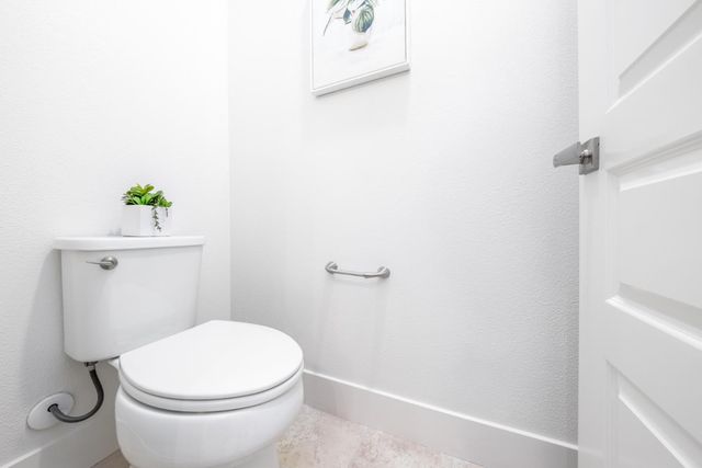 a white toilet sitting next to a white tub