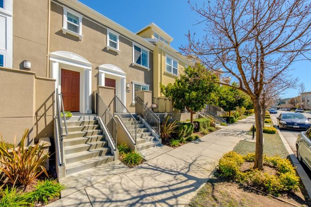 a view of a house with large windows and furniture