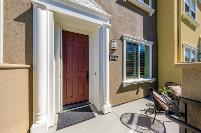 a balcony with table and chairs