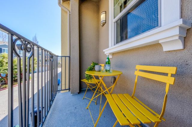 a front view of a house with a garden and plants