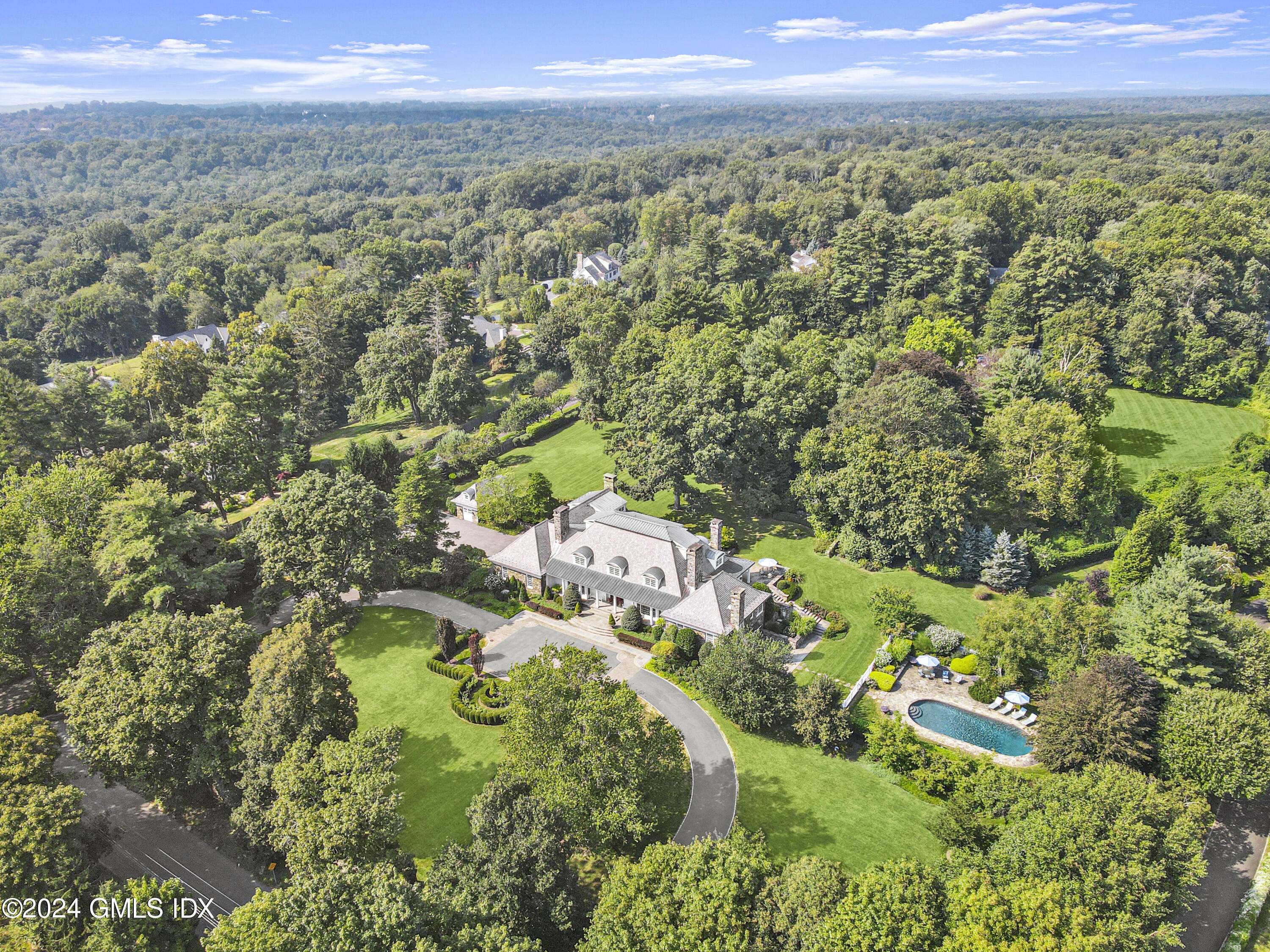 7 Old Mill Road Greenwich, CT 06830 - Photo 1 of 1 a view of a city with lush green forest