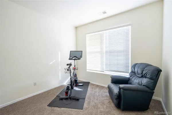 a view of a livingroom with workspace and a window