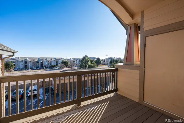 a view of a balcony with wooden floor