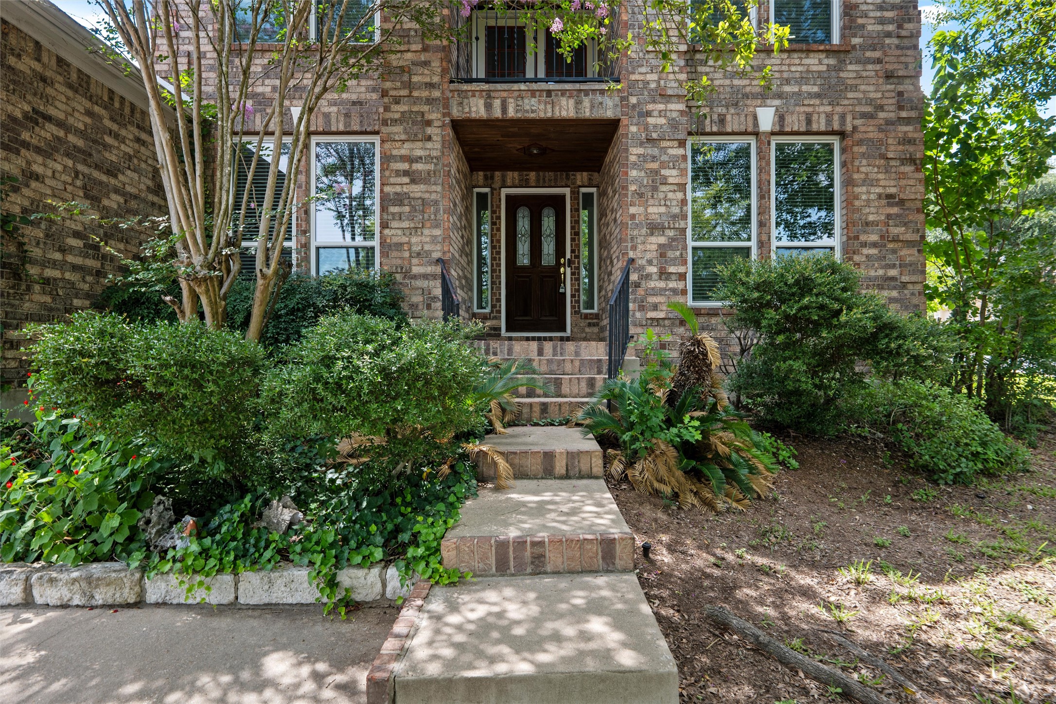 7000 Colberg Court Austin, TX 78749 - Photo 2 of 40 A classic brick exterior with inviting steps leading to a sheltered entry.