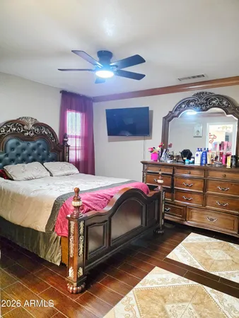 a bedroom with a bed and a chandelier
