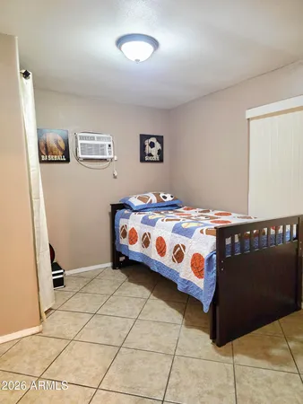 a bedroom with a bed and a window