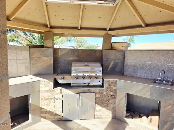 a kitchen with stainless steel appliances kitchen island granite countertop a stove and a sink