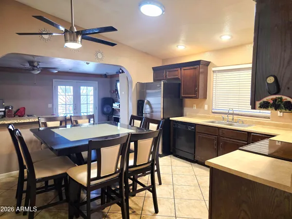 a kitchen that has a table and chairs in it