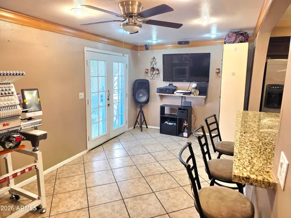 a view of a workspace with furniture and a window