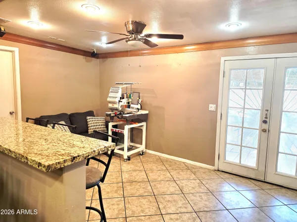 a view of a workspace with furniture and a window