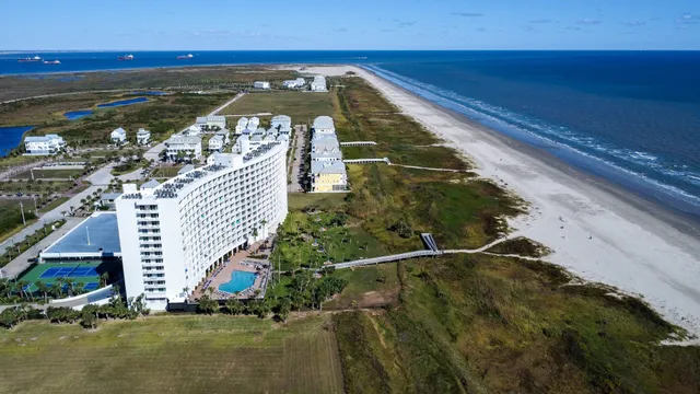 a view of a balcony with floor to ceiling windows