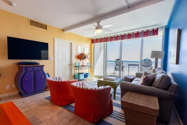 a living room with furniture and a floor to ceiling window