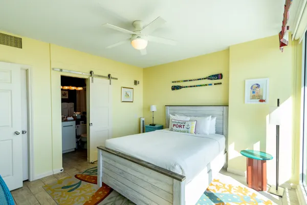 a bedroom with a bed and large window
