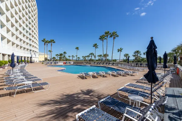 a view of a swimming pool with a table and chairs