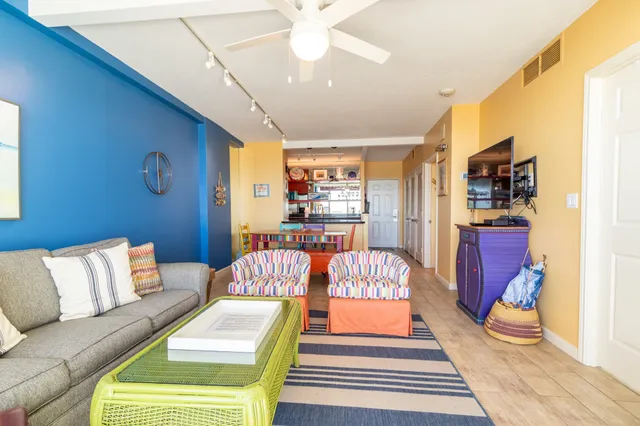 a living room with furniture and a lamp