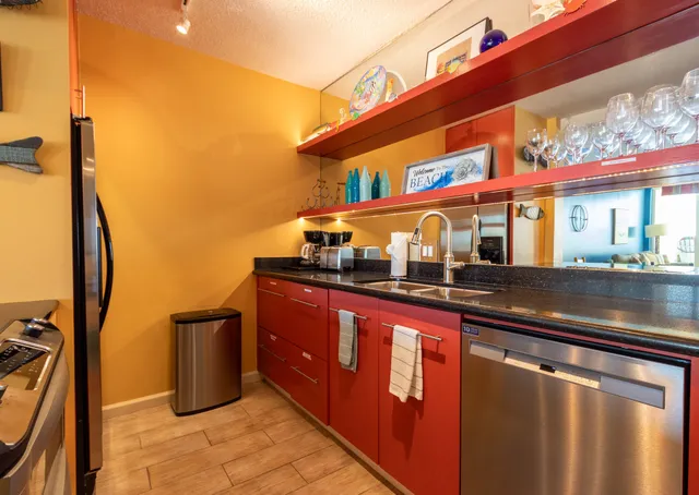 a kitchen with stainless steel appliances granite countertop a sink a stove and a microwave