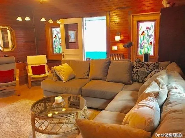 a living room with furniture and painting on the wall