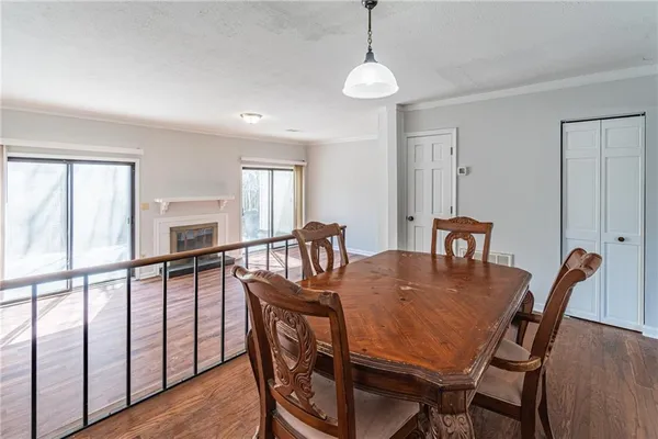a view of empty room with wooden floor and fireplace