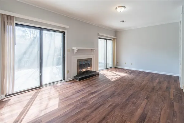a view of a livingroom with furniture wooden floor and chandelier