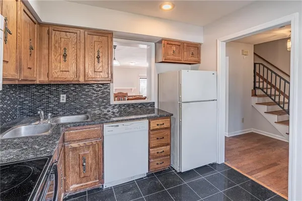 a view of a hallway to a livingroom with furniture
