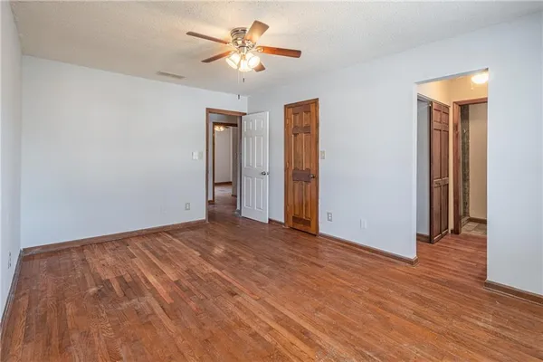 a bathroom with a granite countertop sink a mirror and a toilet