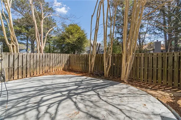 a view of a house with a door and wooden fence