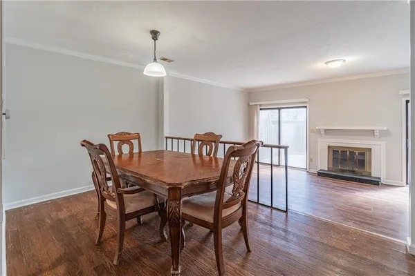 a view of a dining room with furniture wooden floor and a chandelier