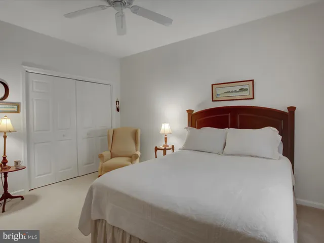 a bedroom with a bed and a lamp