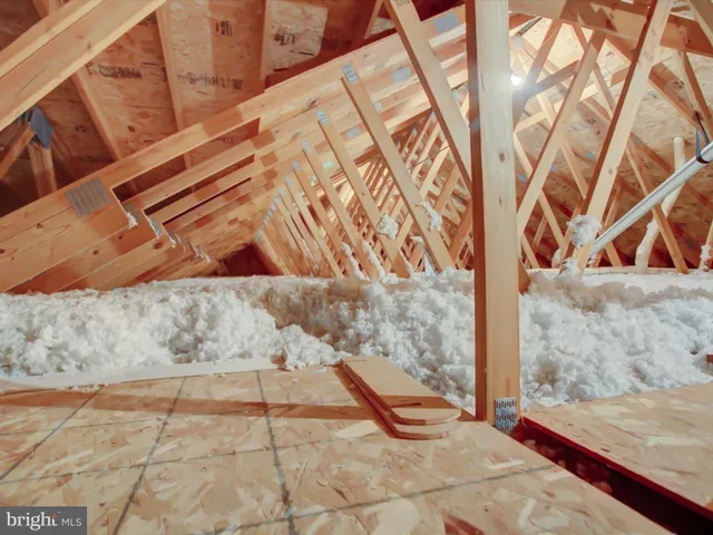 a view of the house with a yard and road