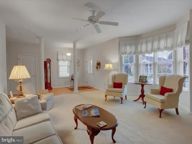 a living room with furniture and a lamp