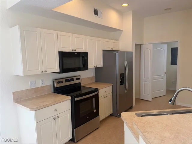 a kitchen with stainless steel appliances a stove microwave and refrigerator