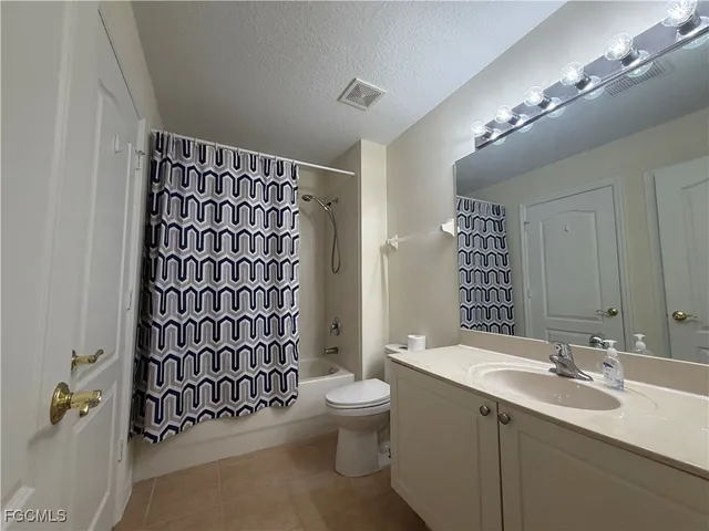 a bathroom with a sink a toilet a shower and a mirror