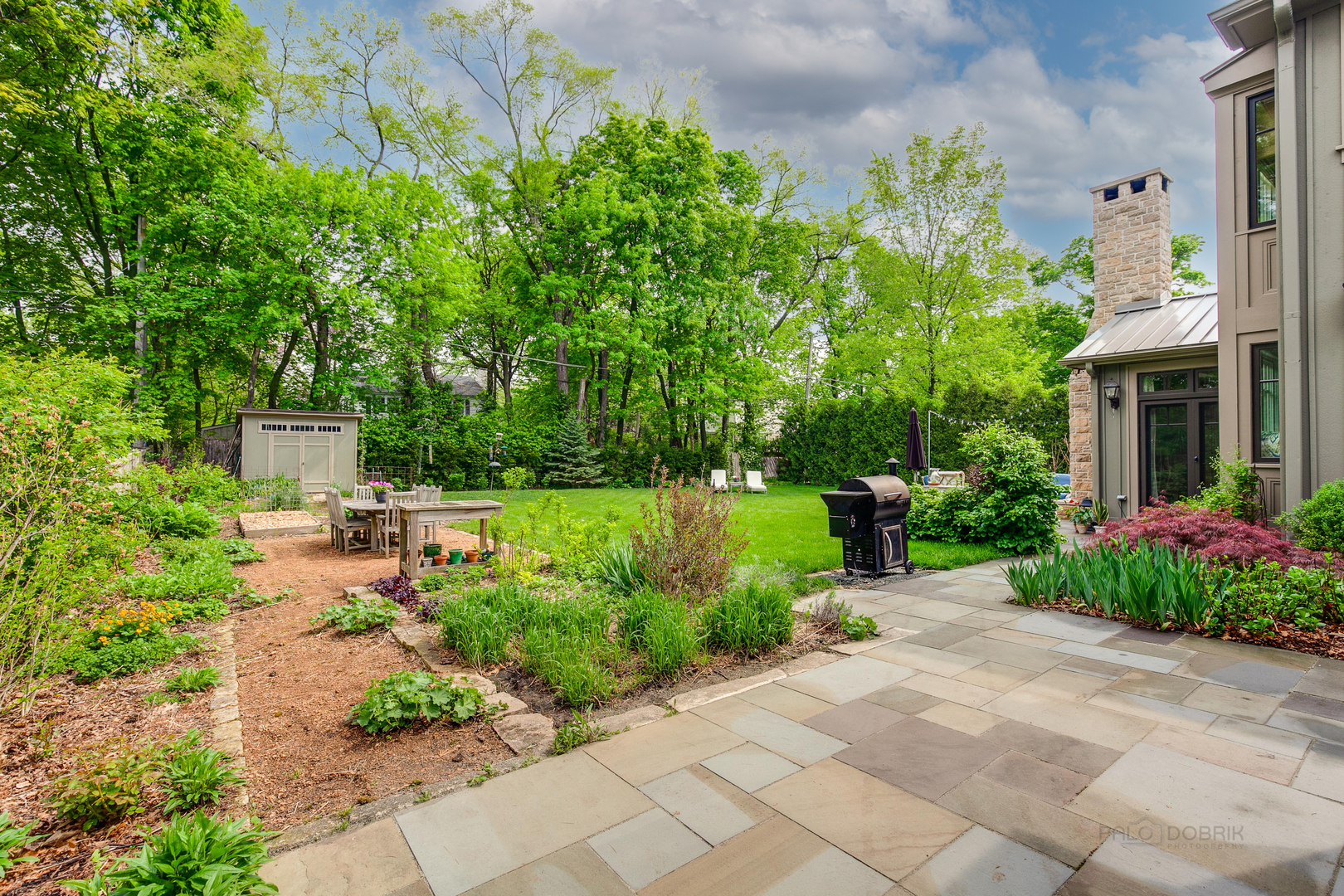 50 Ravine Forest Drive Lake Bluff, IL 60044 - Photo 38 of 44 a view of a garden with potted plants and large trees