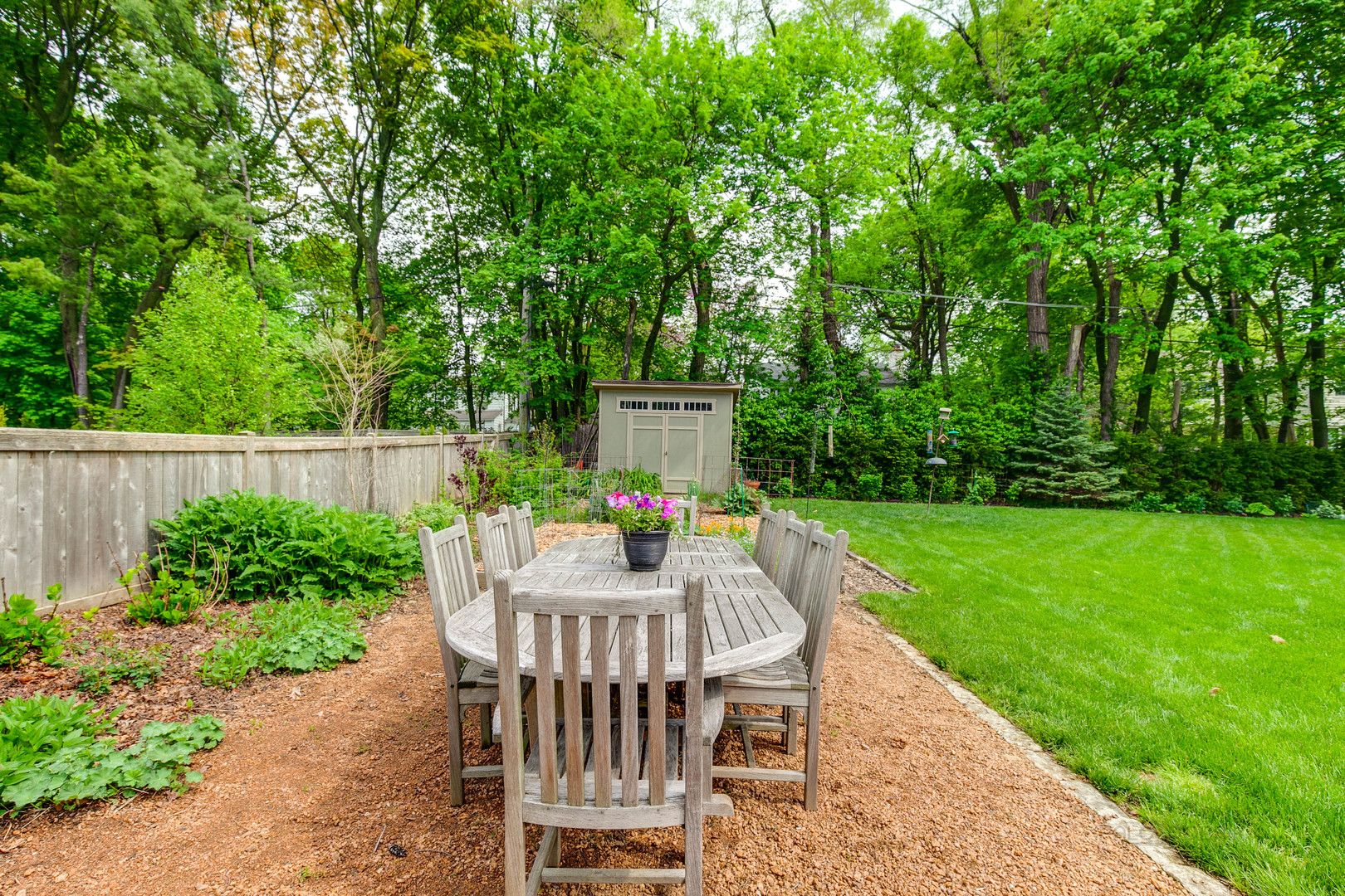 50 Ravine Forest Drive Lake Bluff, IL 60044 - Photo 40 of 44 a view of a table and chairs in back yard of the house