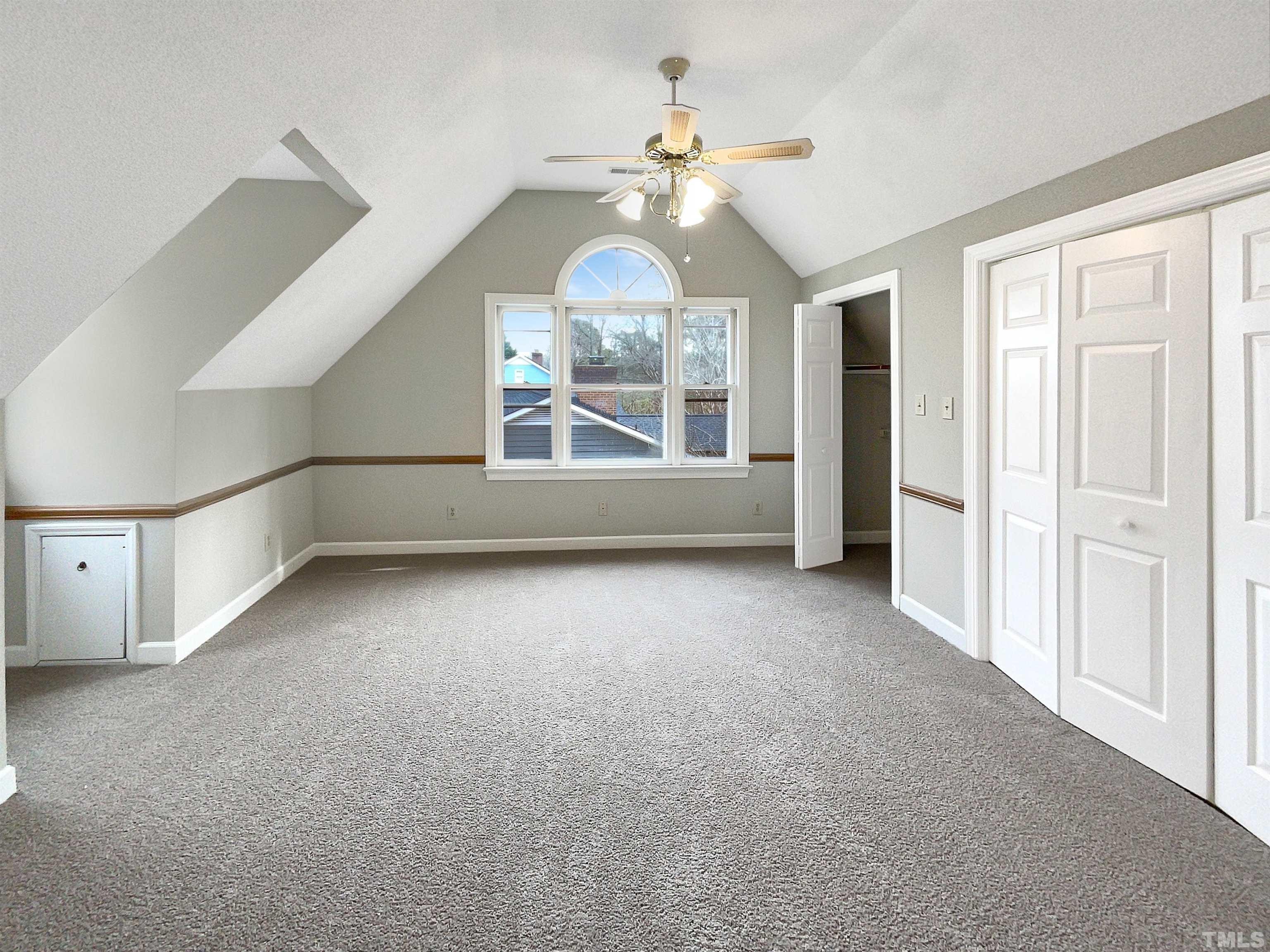6900 Three Bridges Circle Raleigh, NC 27613 - Photo 12 of 20 an empty room with windows and chandelier