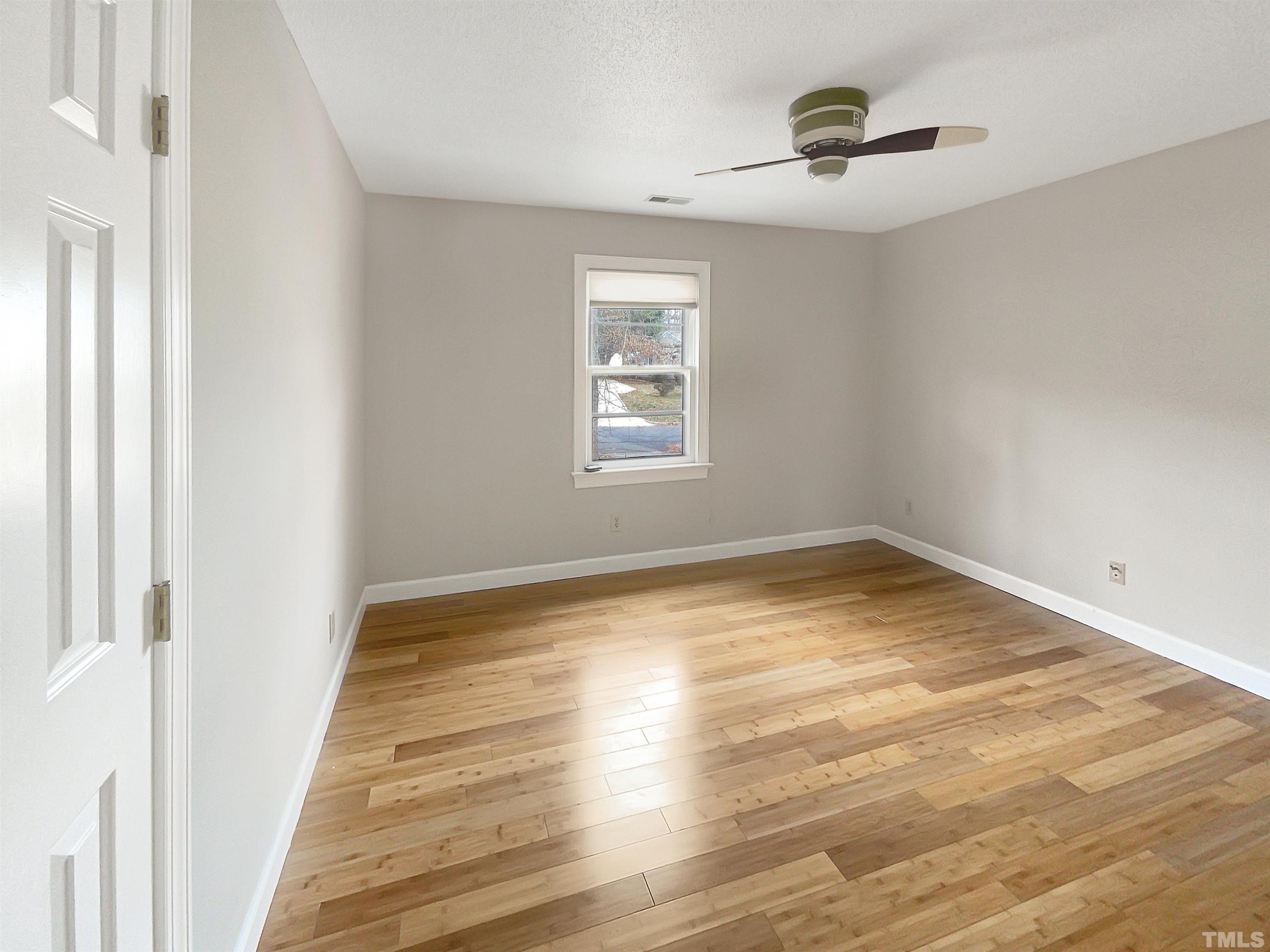 6900 Three Bridges Circle Raleigh, NC 27613 - Photo 14 of 20 a view of empty room with wooden floor and fan