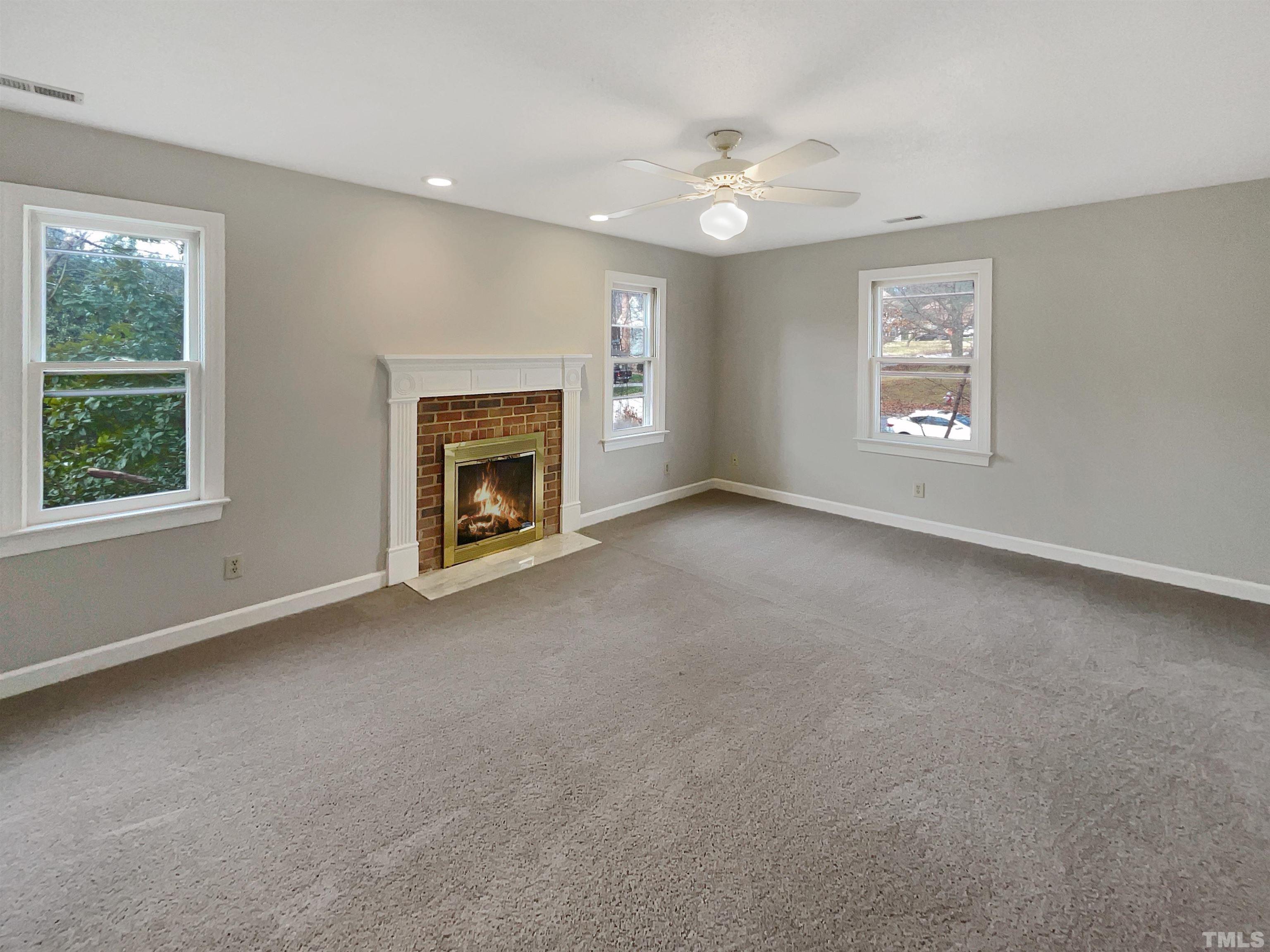 6900 Three Bridges Circle Raleigh, NC 27613 - Photo 17 of 20 a view of empty room with fireplace