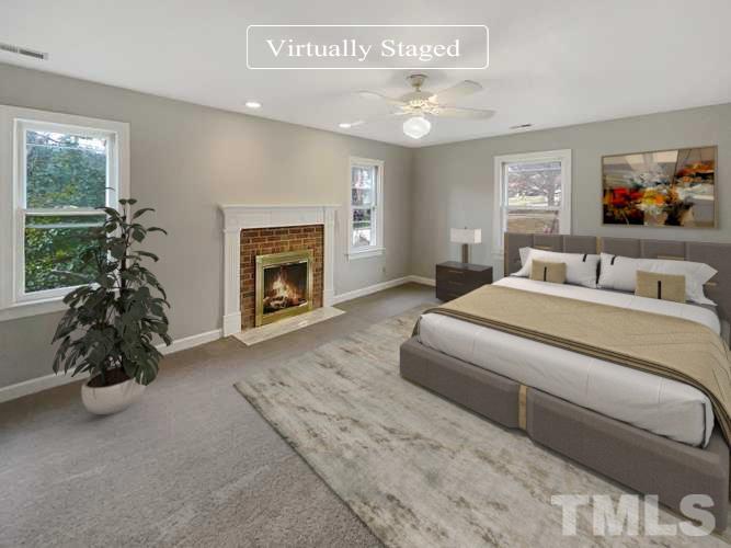 6900 Three Bridges Circle Raleigh, NC 27613 - Photo 3 of 20 a bedroom with a bed and a fireplace