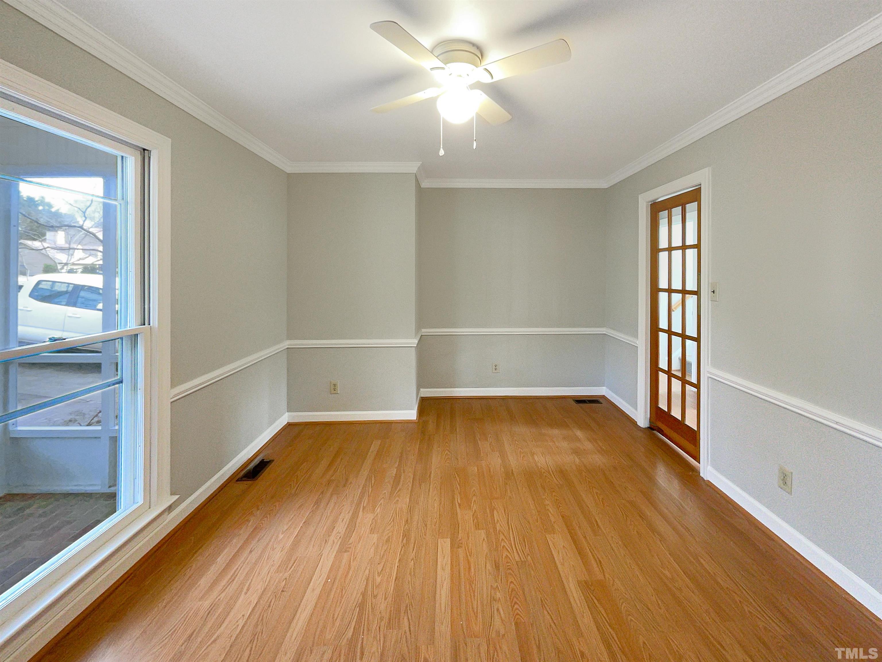 6900 Three Bridges Circle Raleigh, NC 27613 - Photo 9 of 20 wooden floor in an empty room with a window
