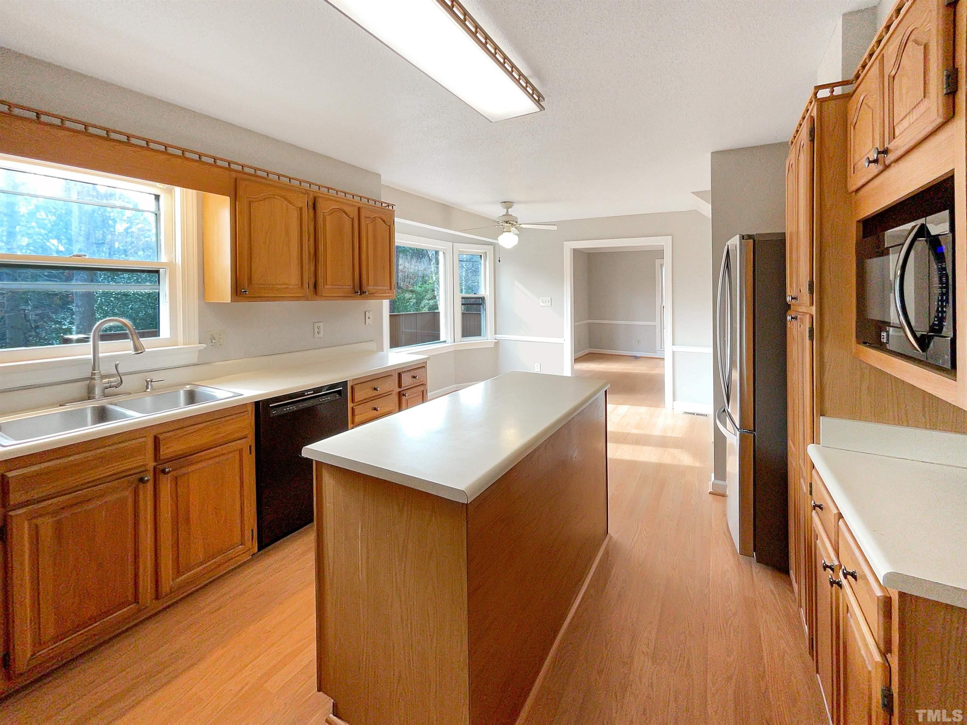 6900 Three Bridges Circle Raleigh, NC 27613 - Photo 10 of 20 a kitchen with stainless steel appliances granite countertop a sink and a stove