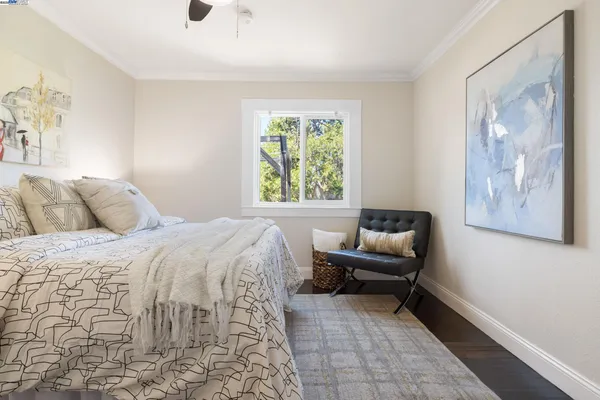 a bedroom with a bed and a painting on the wall