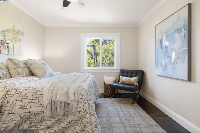 a bedroom with a bed and a painting on the wall