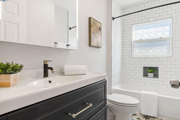 a bathroom with a toilet a sink and bathtub