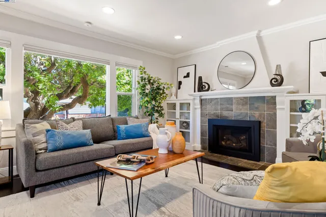 a kitchen with stainless steel appliances granite countertop a kitchen island hardwood floor sink stove dining table and chairs