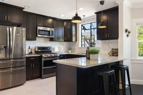 a kitchen with a sink stove and microwave